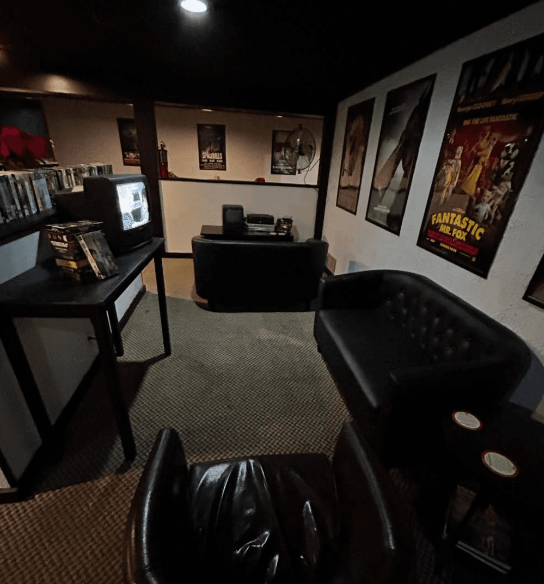 Royale Cinema Lounge's VHS video lounge, with tapes, posters, and a CRT television